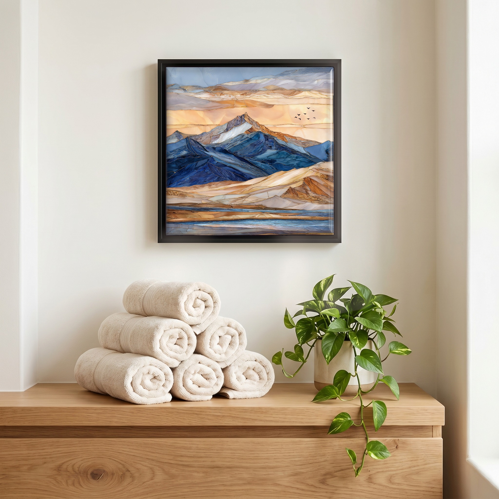Above the linens, in a slim black surround.