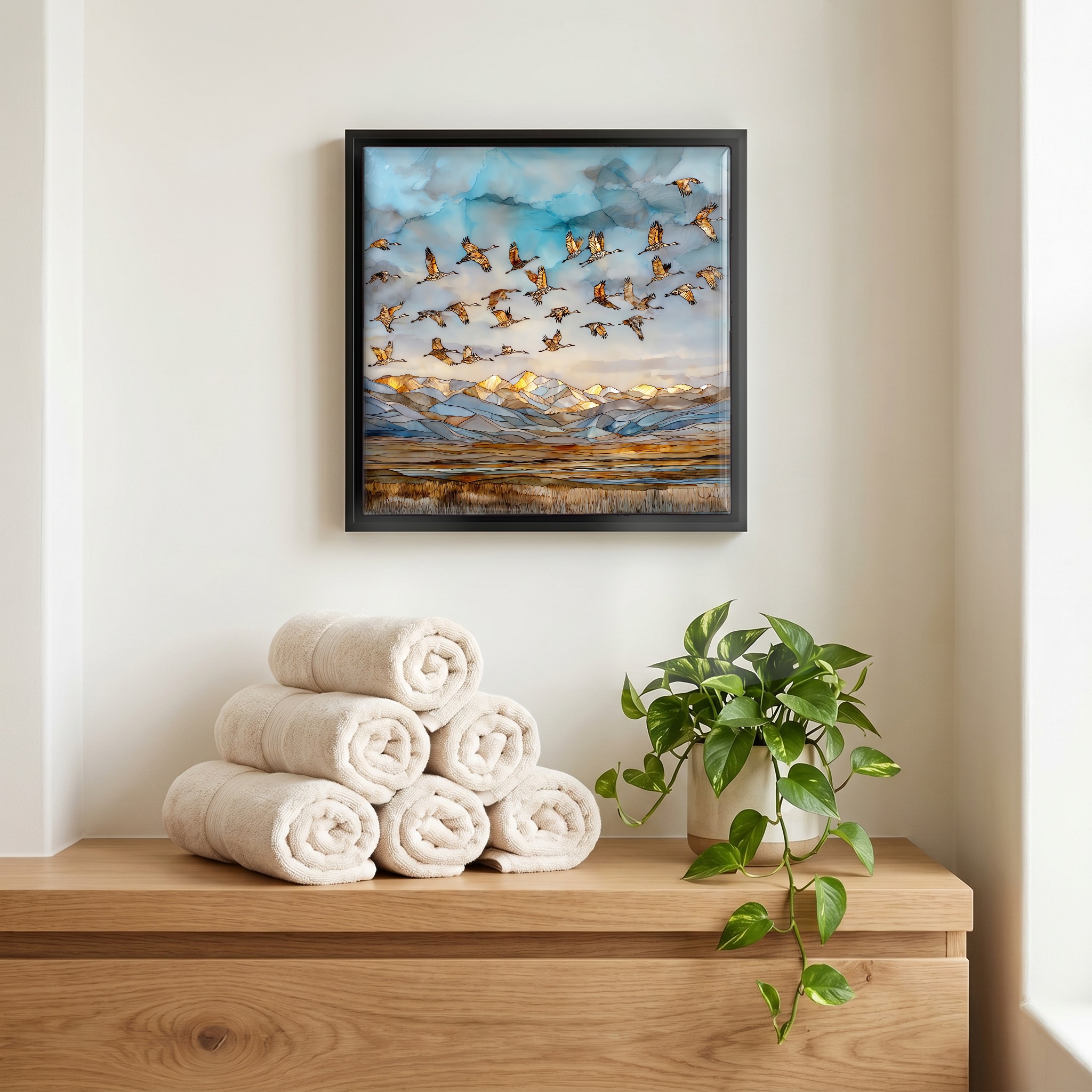 Above the linens, in a slim black surround.