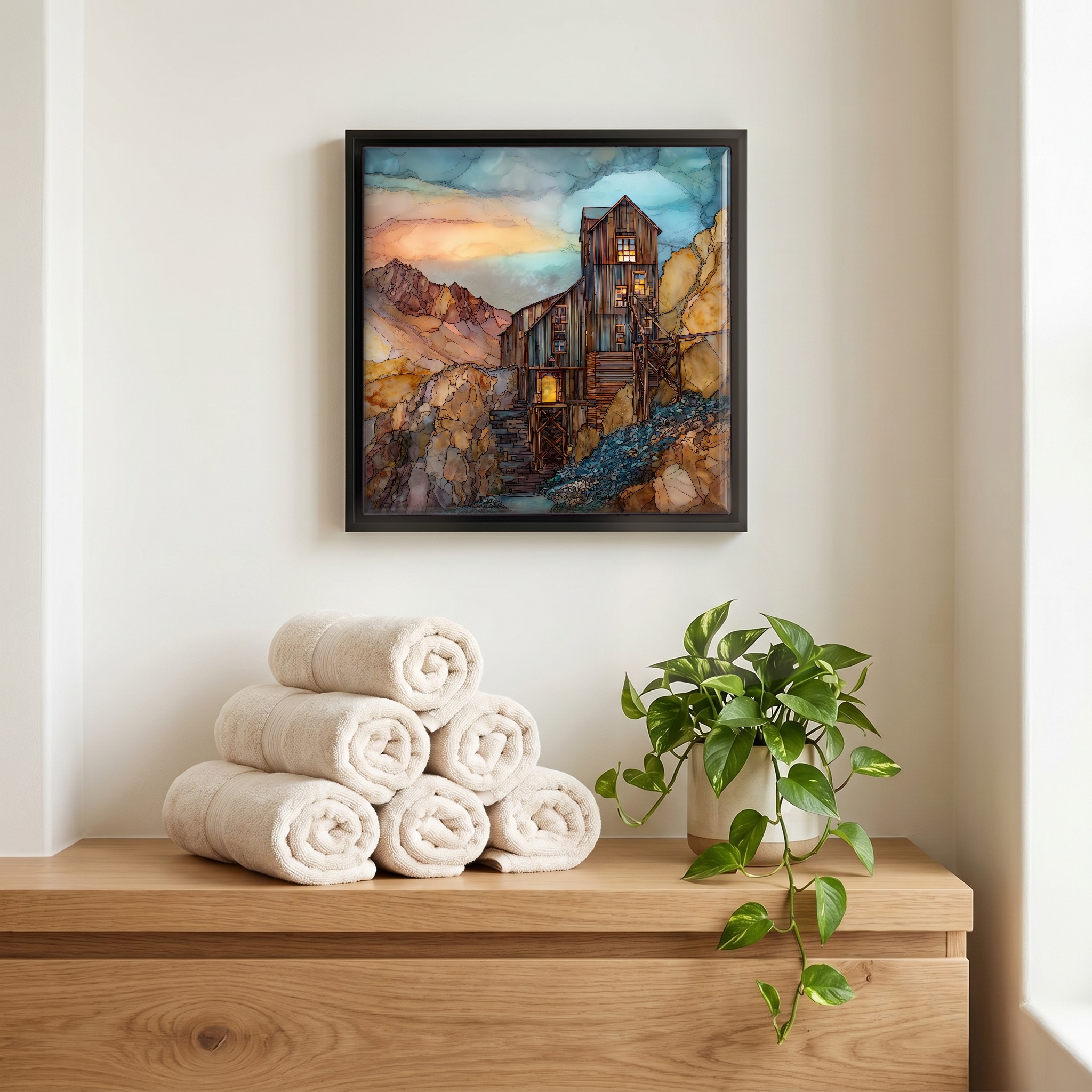 Above the linens, in a slim black surround.