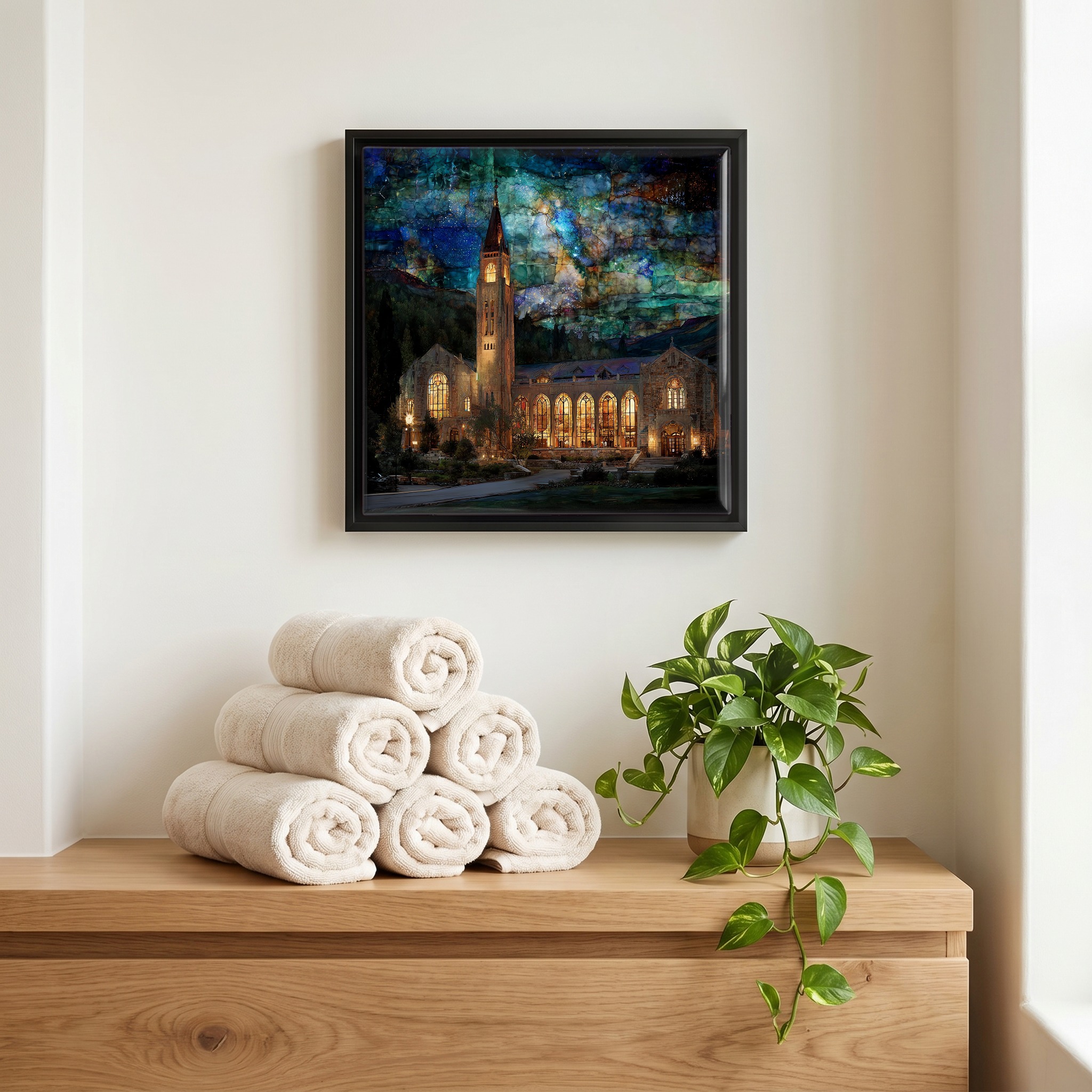 Above the linens, in a slim black surround.