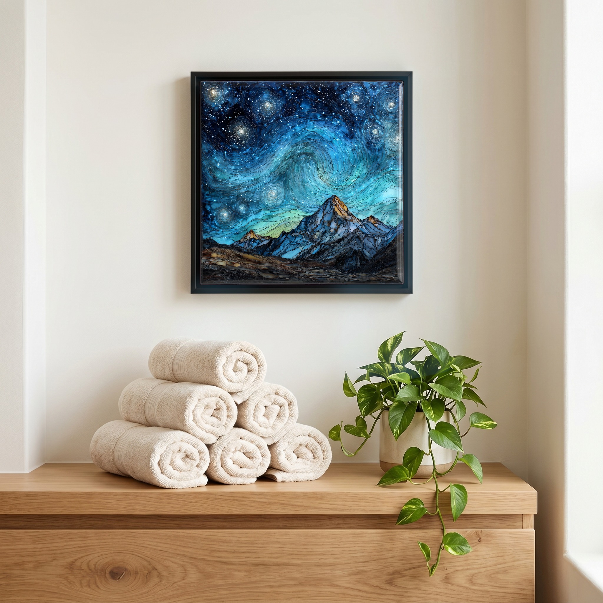 Above the linens, in a slim black surround.