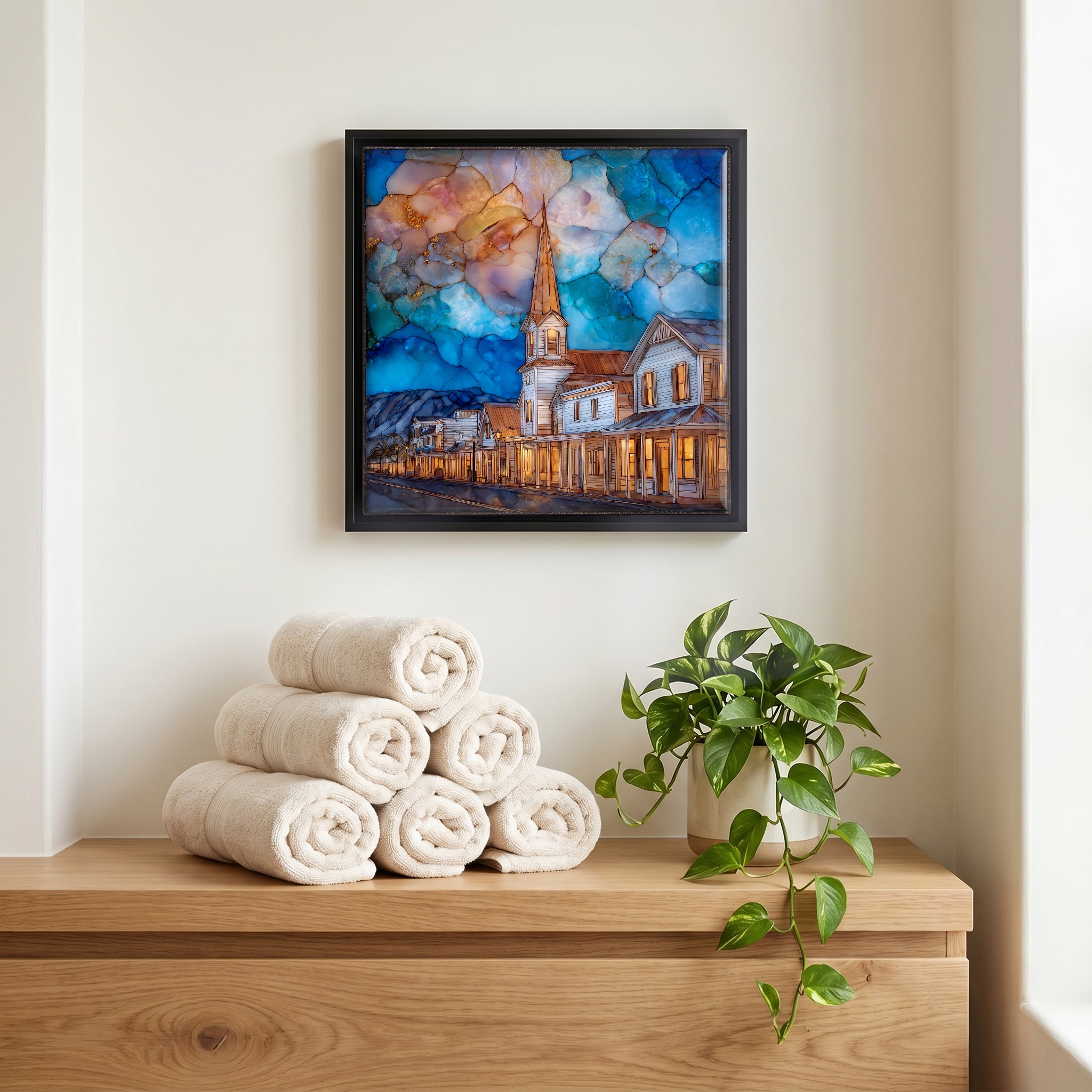 Above the linens, in a slim black surround.