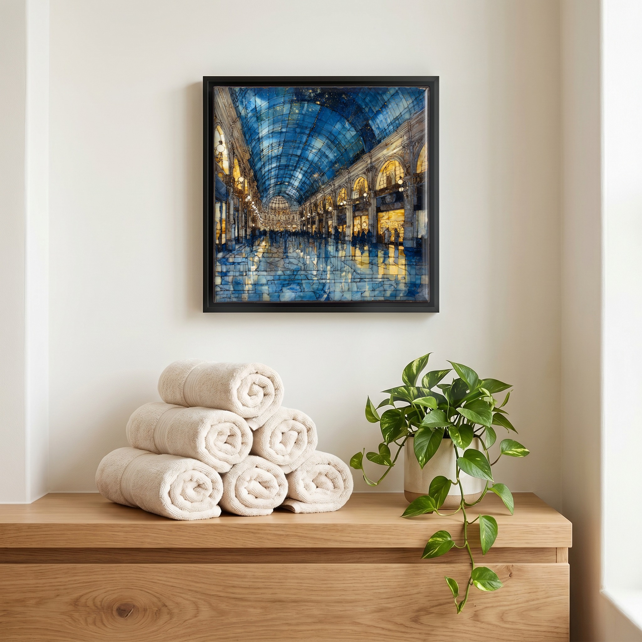 Above the linens, in a slim black surround.